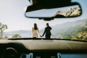 honeymoon couple travel by car in mountains