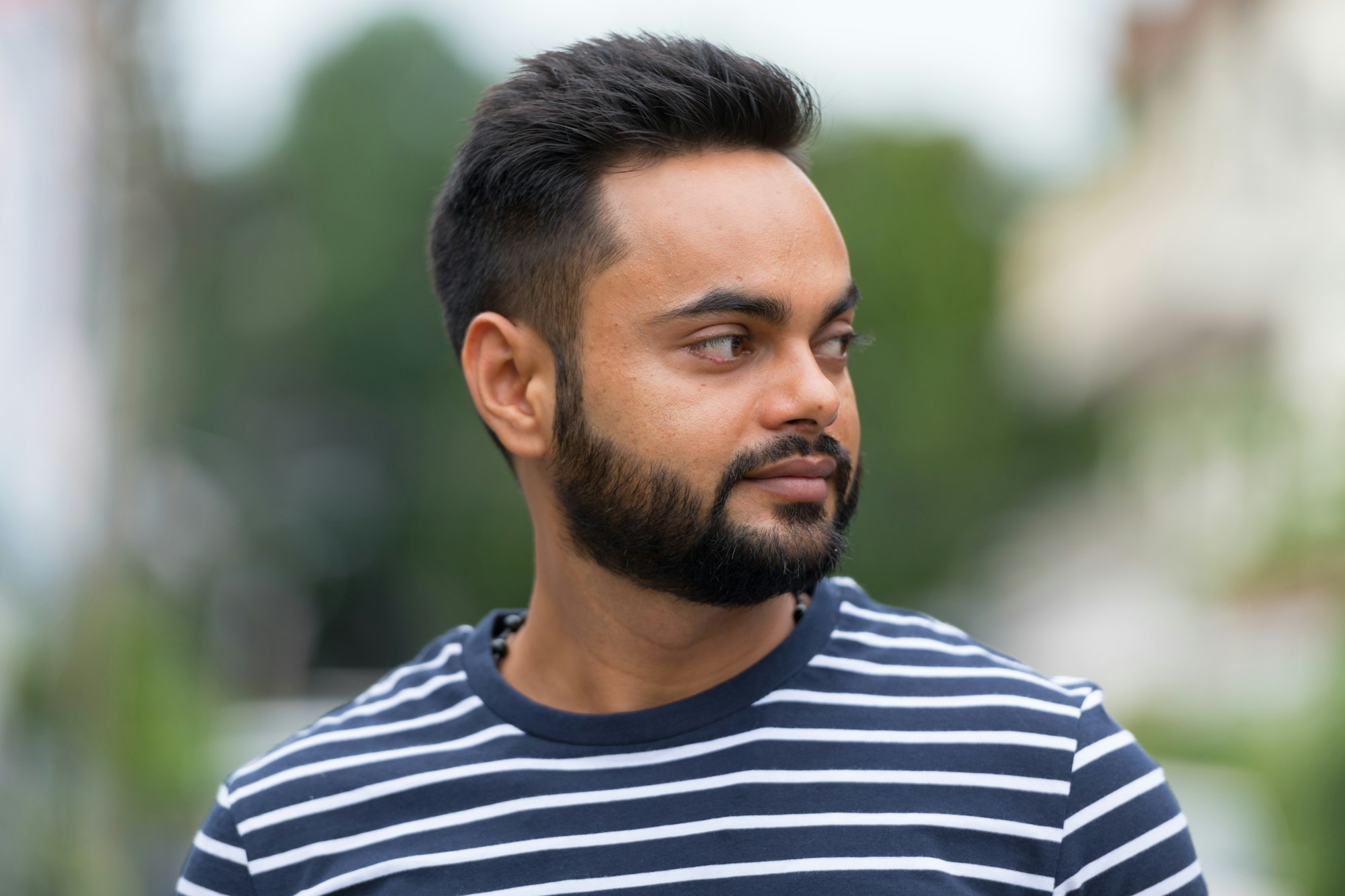 Young bearded Indian man in the streets outdoors